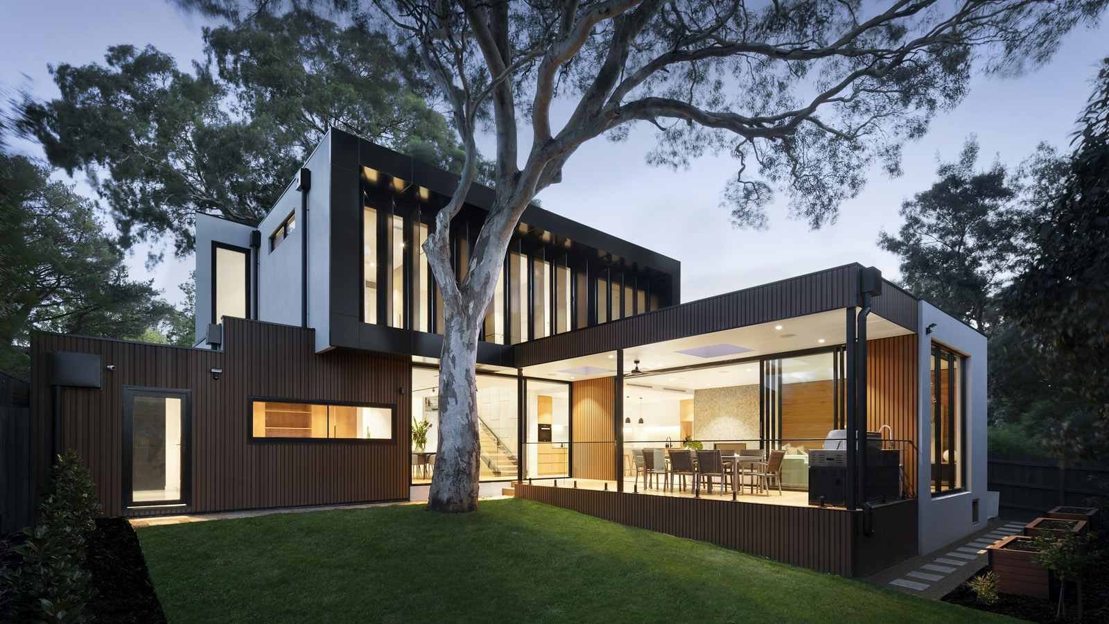 A modern private residence lit at dusk, kept ready for its owner's return
